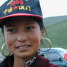 A close up of a 14 year old Tibetan girl wearing a baseball cap.