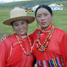 A close up of two dancers wearing red shirts.
