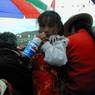 A young Tibetan girl drinking from a Pepsi bottle.