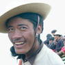 A close up of a Tibetan man laughing.