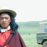 A close up of a long haired young Tibetan man.