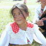 A young Tibetan girl sitting on the ground.