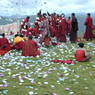 Monks offering paper prayer flags on top of one of the hills above Larung Gar.