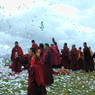 Monks offering paper prayer flags on top of one of the hills above Larung Gar.