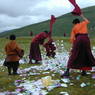 Monks gathering paper prayer flags.