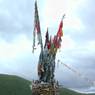A close up of the hilltop cairn and prayer flags.
