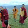 A Chinese monk, layman, and lamas near the cairn on top of Jomo Hill.