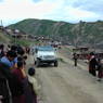 People bowing and greeting Khenpo Jikme Phutsok, the founder of the Larung Gar religious community, as he arrives in his car.