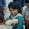 Tibetan children with a puppy just outside the entrance to the monastery.
