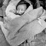 Baby in cot at Tibetan camp north of Pokhara
