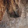An elevated masonry cell in the cave’s façade.