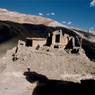 The partially rebuilt Chuser (<i>chu gser</i>) Monastery with wall traces of the runined castle all around it.