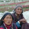 Two village woman relaxing in front of village