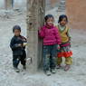 Three kids in front of Jo khang lha khang of 'Khor chags dgon pa