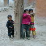 Three kids in front of Jo khang lha khang of 'Khor chags dgon pa