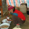 dMig mar lha mo 17 years old in 2nd floor of Ka brgya lha khang in kitchen with three walls