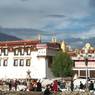 Main Jokhang entrance, with seventh-century Wönzhang Pillar (<i>rdo ring</i>) visible against the white wall at lower left.