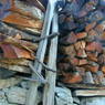 Wood piled as a fence around a house in the village of Lo, in Kong po