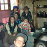 Women and children gathered in a traditional kitchen in the village of sMu pa, in Kong po