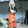 Young woman from well-to-do Limbu family feeds chickens
