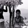Two village girls near maize storage platform (tengro)