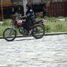 Tibetan man riding motorcycle in Lhagang town.&nbsp;