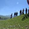 Men walking up hill at Lhagang Horse Festival.&nbsp;