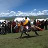 Tibetan boy racing horse in Lhagang