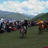 Tibetan men horseracing at Lhagang Horse Festival.&nbsp;