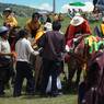 Tibetan men milling about in preparation of Horse Festival