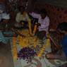 Making flower garland for their brothers