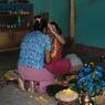 Woman applying tika to her elder sister